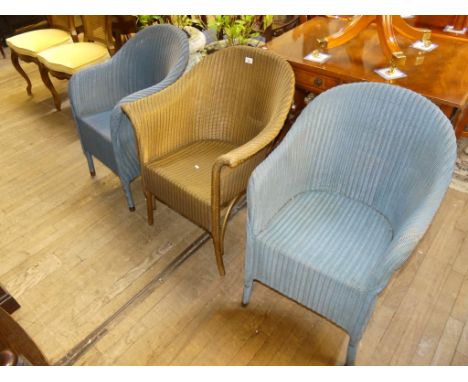 A pair of blue of Lloyd Loom chairs, together with a further gold example of differing design (3) 