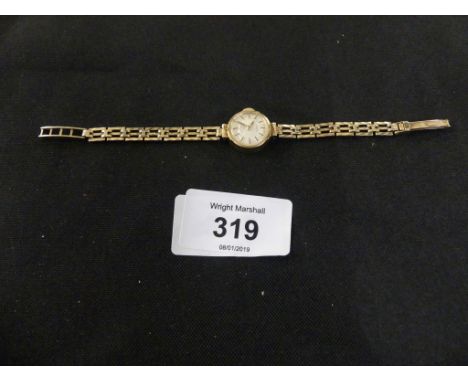 A ladies 9ct gold Rotary watch the circular cream dial with baton hour markers, and integral fancy link bracelet.CONDITION RE