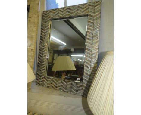 A bevelled wall mirror, in mother of pearl finish frame 