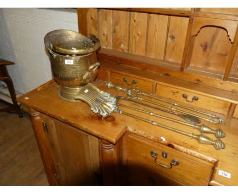 A brass coal bucket together with a selection of brass fire tools and a horses head shoe horn 