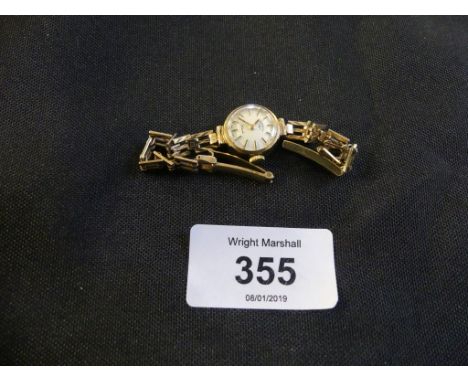 A ladies 9ct gold Rotary wrist watchThe circular white dial with baton hour markers and fancy link bracelet.strap stamped 375