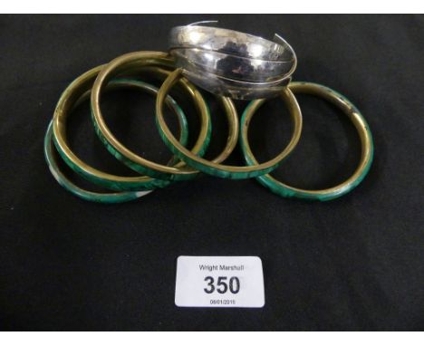 A selection of banglesTo include five malachite bangles and one white metal bangle, stamped 925. 