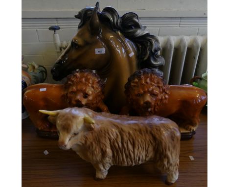 A mixed lot comprising a pair of Staffordshire model lions, a Melba ware model bull and a farther Continental ceramic horses 