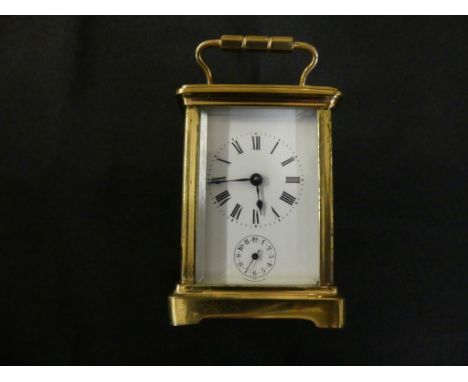 A small brass cased carriage alarm clock with white enamel dial, brass movement and bell beneath, unsignedNo key, movement is