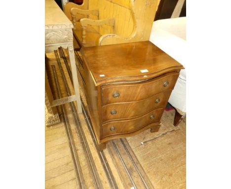 A small reproduction mahogany serpentine front three drawer chest raised on bracket feet 