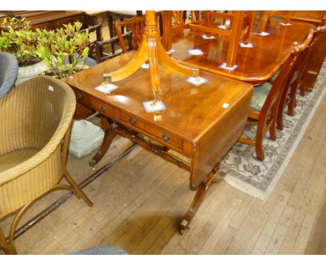 A reproduction mahogany veneered sofa table, fitted with frieze drawers raised on lyre end supports with brass end caps and c