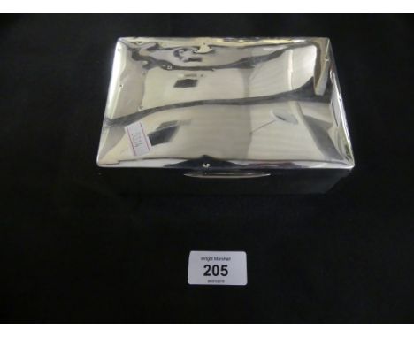 A silver cigarette case of hinged rectangular form with wood lined interior, hallmarks erased 