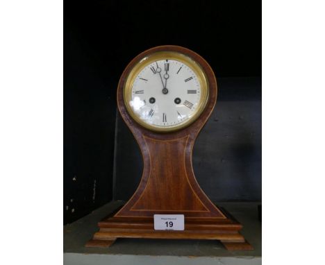 An Edwardian mantel clock set in a mahogany and inlaid balloon form case 
