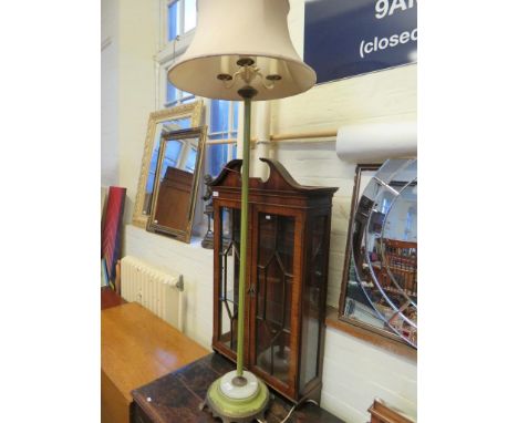 An early 20th Century three light standard lamp, set on a circular column with polished onyx base 