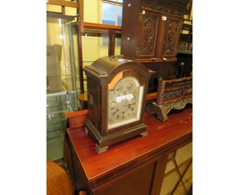 An early 20th Century bracket type clock with arched silvered dial 