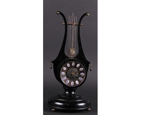 A wooden black lacquered harp mantel clock with open pendulum. France, mid 20th century. Tested for operation.H.: 43 cm.