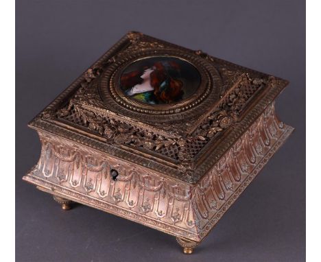 An Art Nouveau, brass jewelery box with enamel plaque of a young woman. about 1880.13 x 13 x 9 cm. 