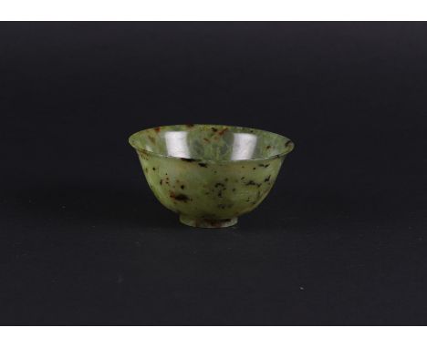 A Celadon Jade bowl with speckled decor. China, 19th/20th century.Diam.: 10 cm.