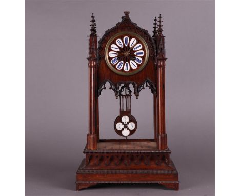 A wooden, neo-Gothic mantel clock with enamelled numerals, First half 19th century. Movement has been checked and works. Smal