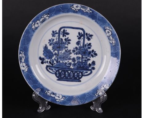 A porcelain bordje with handle basket decor center decor and `broken' ice outer rim decor. China Kangxi marked with 6-charact