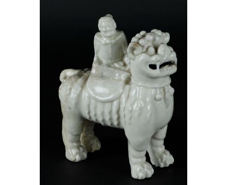 A porcelain Blanc de Chine Foo-dog with a mounted&nbsp;figure. China, Kangxi.Afm.: 16 x 13 cm.
