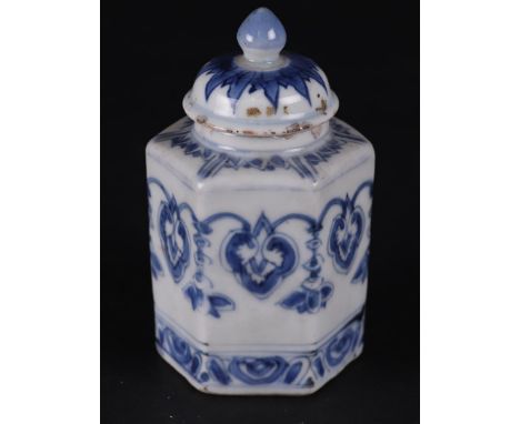 A porcelain 6-sided tea caddy with continuous garland decoration and with tobacco leaf decoration around the neck and on the 