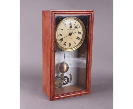 An electric "Brille" wall clock, circa 1930.Afm.: 45 x 24 cm.