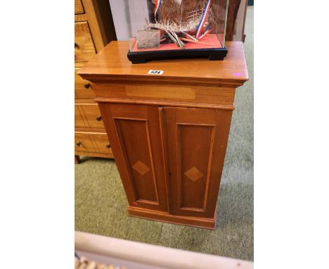 Walnut two door cabinet with shelves to interior with inlaid panel doors. 78cm in Height 