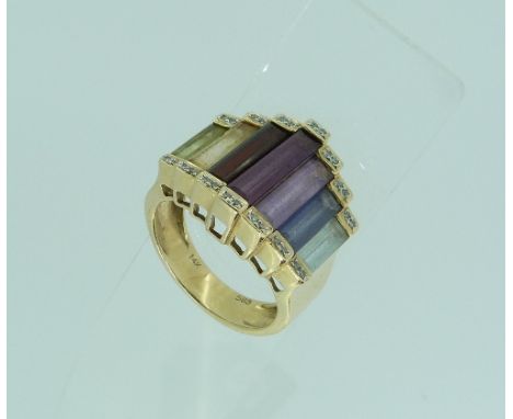 A stylish Ring, of Art Deco design, the domed front set with graduated baguette stones of varying colours including amethyst,