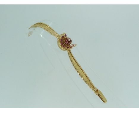 A Lucien Piccard 14ct gold gem-set lady's wristwatch, the covered watch in the form of a peacock set with rubies and central 