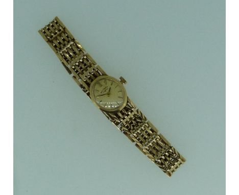 A 9ct gold Rotary lady's wristwatch, oval gilt dial with baton markers, on a gate-link flexible bracelet.