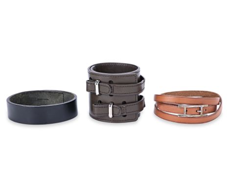 A GROUP OF THREE HERMES LEATHER BRACELETS
Comprising an Hermes Hapi leather bracelet, brown with gold hardware, Hermes dark b
