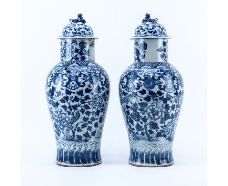 Pair of Mid Century Chinese Blue and White Porcelain Covered Urns with Foo Dog Finial. Unsigned. One has a repair to rim. Mea