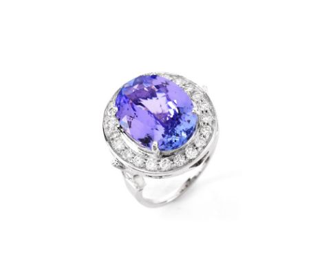 AIGL Certified 7.0 Carat Oval Cut Tanzanite, .70 Carat Diamond and 14 Karat White Gold Ring. Tanzanite with vivid saturation 