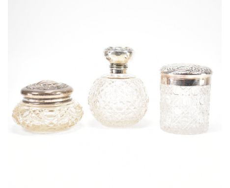 A group of three Victorian / Edwardian silver topped dressing table pots. The lot to include a cut glass scent bottle with a 