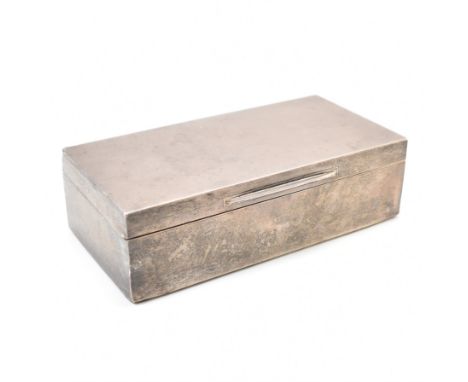 A silver hallmarked desk top cigarette box. The rectangular box having engine turned decoration with a wooden lined interior.