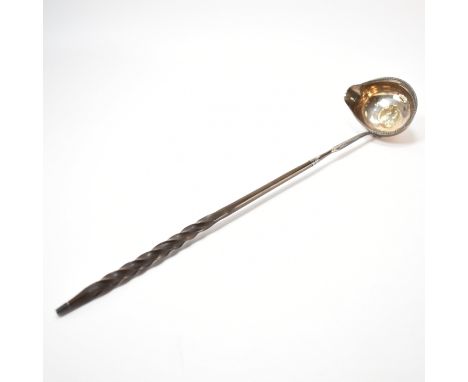 A 19th Century George III silver hallmarked ladle. The ladle having a twisted whale bone handle, the bowl having a George III