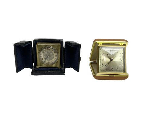 Two 20th century compact traveling alarm clocks -  in blue case with opening doors and an Equity travel clock, both wound and