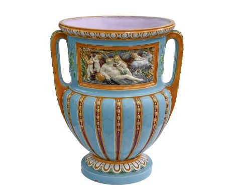 A Minton majolica vase, 1870, moulded in high relief to each side with a panel of centaurs or Bacchus, in ochre frames on a t