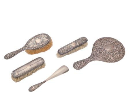 A George V silver hand mirror, by J &amp; R Griffin, Chester 1917, three silver brushes and a silver handled shoe horn (5)  G