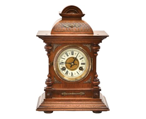 A German walnut mantel clock, c1900, with primrose enamel chapter ring and gong striking movement, pendulum, 35cm h  Good con