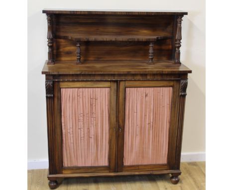Regency rosewood chiffonier the upper section raised on carved turned supports over a  pair of fabric covered doors on bun fe