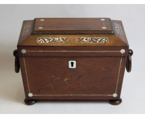 Early 19th century rosewood tea caddy of twin handled sarcophagus form, with Mother of Pearl foliate inlay and stringing, the