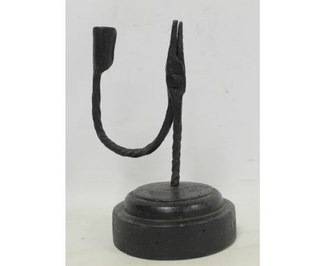 Antique wrought iron rush light on stained wooden domed plinth base (some worm), 20cm high.