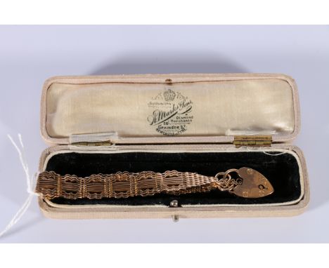 Edwardian gold bracelet of ten link gate style, with padlock by Grinsell & Sons '9ct', little used. 24g.  