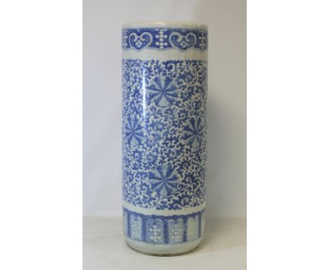 Large Chinese blue and white porcelain stick stand of cylindrical form with floral and foliate scroll decoration, 60cm high. 