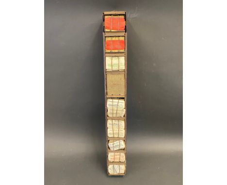 A rectangular ticket dispenser, containing various early labels etc.