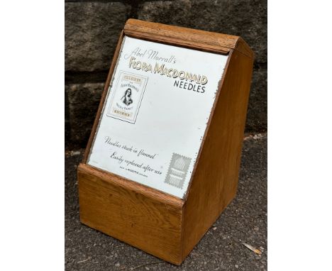 A light oak counter top dispensing cabinet for Flora Macdonald Needles, with five pull-out drawers to the rear, 8" w x 12 1/2