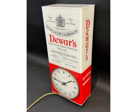 A wall hanging Smiths electric clock within a plastic case advertising Dewar's Finest Scotch Whisky, 7" w x 16" h x 3 1/2" d.