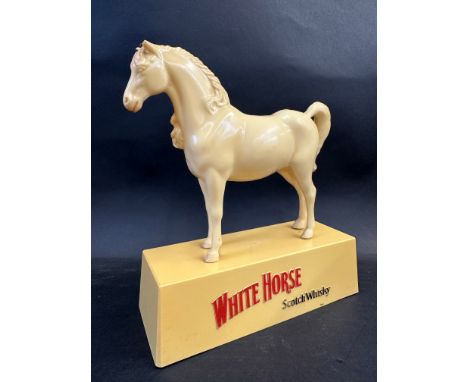 A White Horse Scotch Whisky plastic advertising figure, 9 1/4" w.