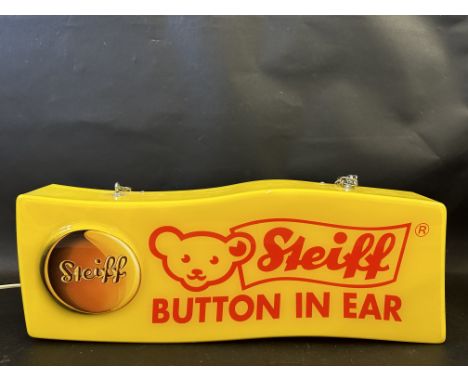 A plastic lightbox advertisng Steiff 'Button In Ear', 20" wide x 7 1/2" high x 3" deep.