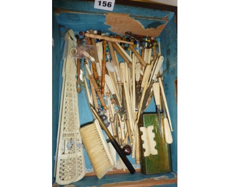 Wooden box containing large quantity of antique carved ivory and bone sewing and vanity accessories. Some button hooks, lace 