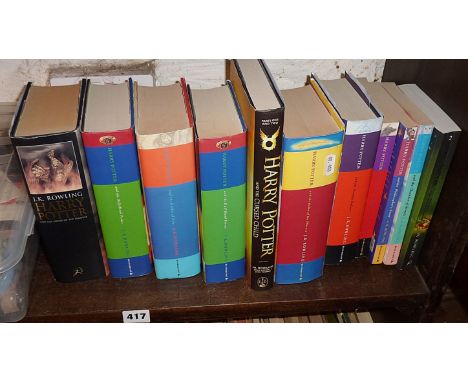 Eleven Harry Potter books, some hardback. An edition of the Philosopher's Stone by Bloomsbury with copyright text as Joanne R