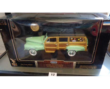 A Signature series scale diecast model of a 1948 Ford "Woody" in original box with coin and surfboard