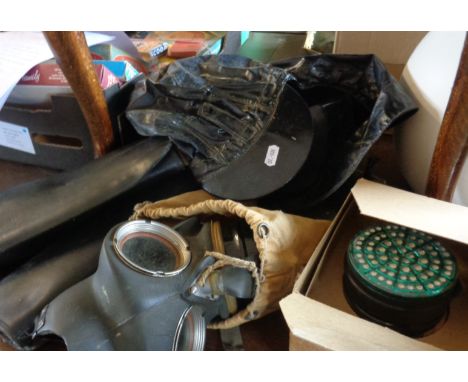 Two WW2 gas masks, pair WW2 leather gaiters, a 1953 naval deck hat and an army bedroll